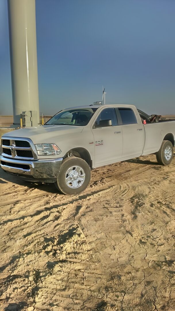 White pickup truck on sandy terrain