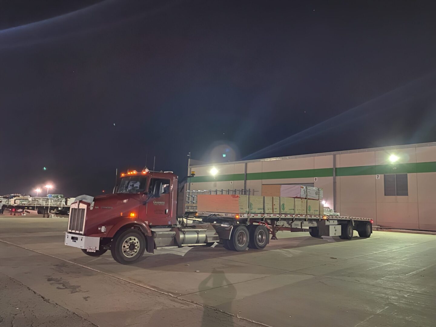Flatbed truck in dimly lit lot