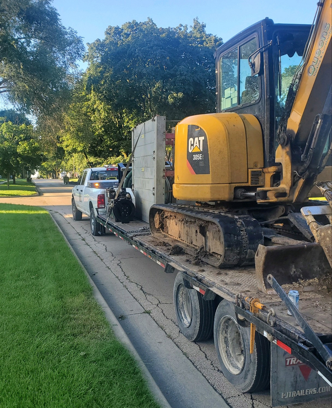 Yellow CAT excavator loaded on trailer