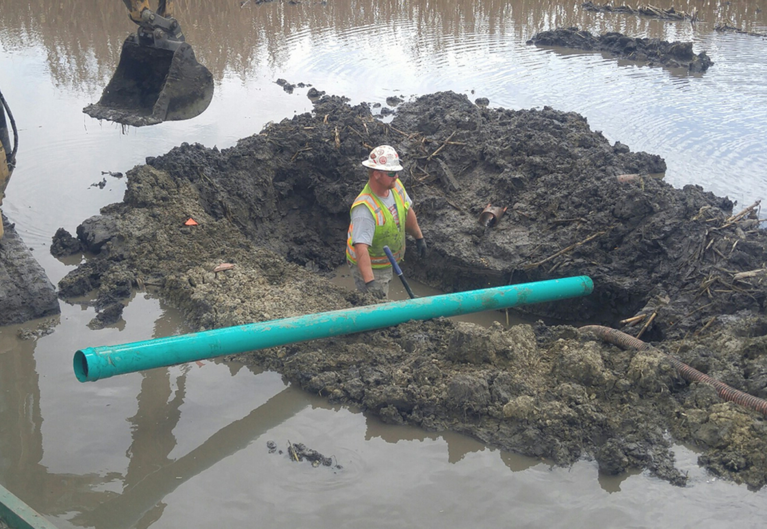 Construction worker in a muddy pit