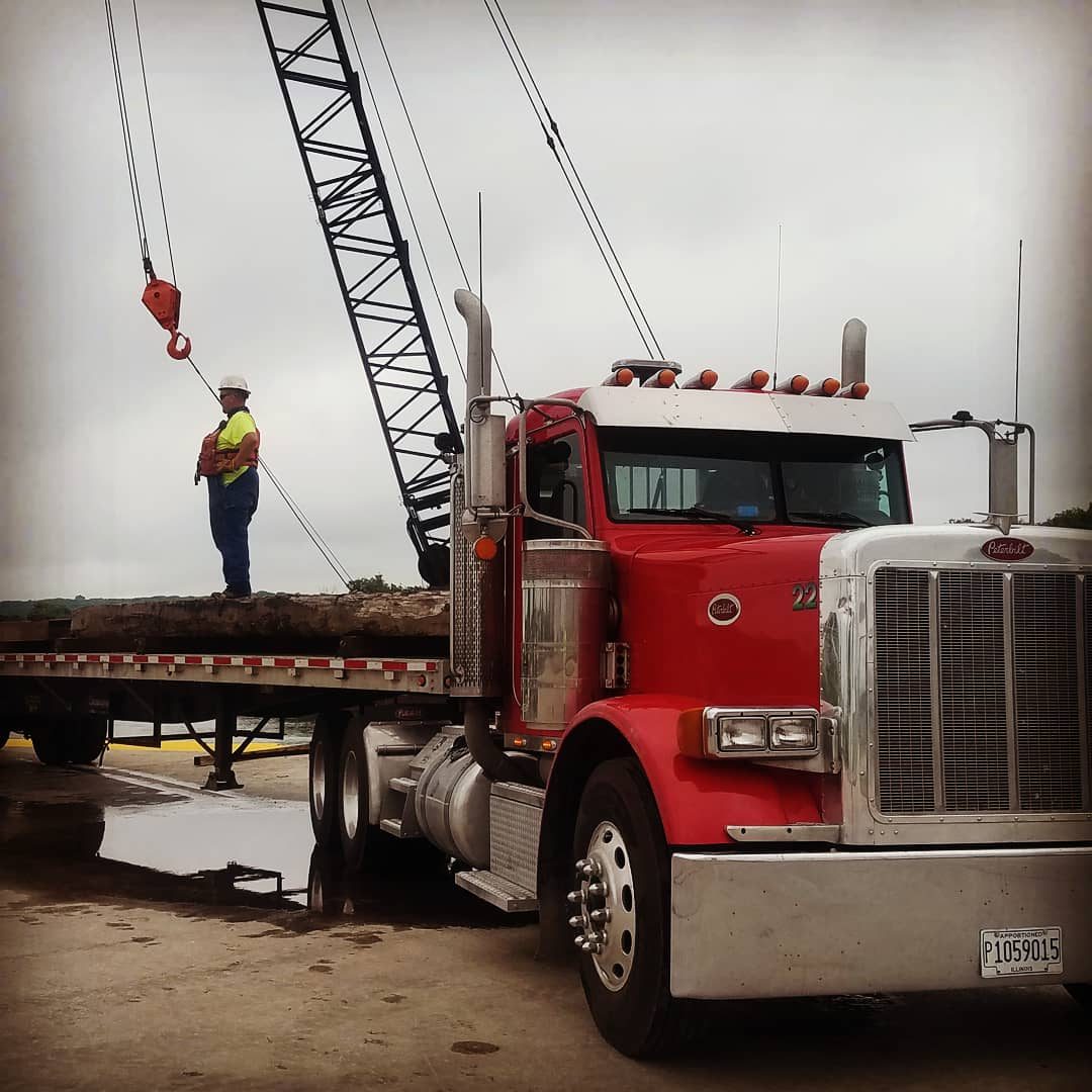 Red truck with crane and worker