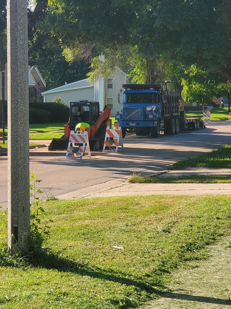 Roadwork signs and machinery in suburbia