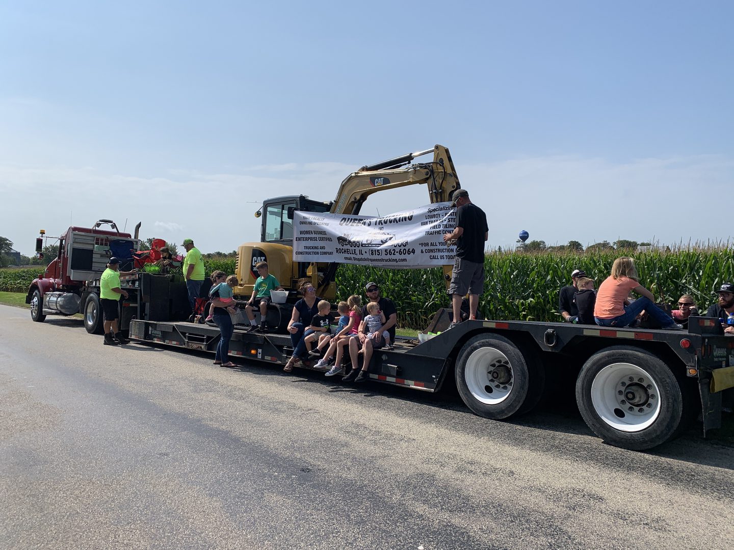 Excavator and people on a trailer