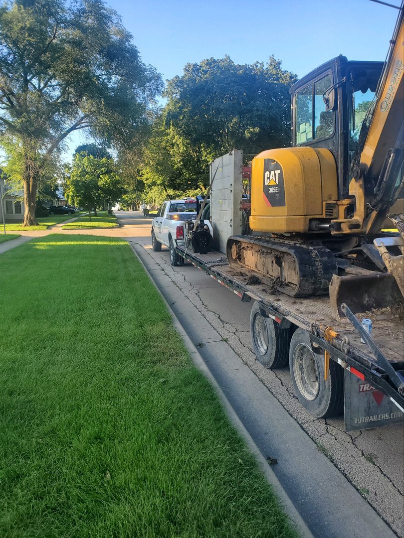 Yellow excavator on a flatbed