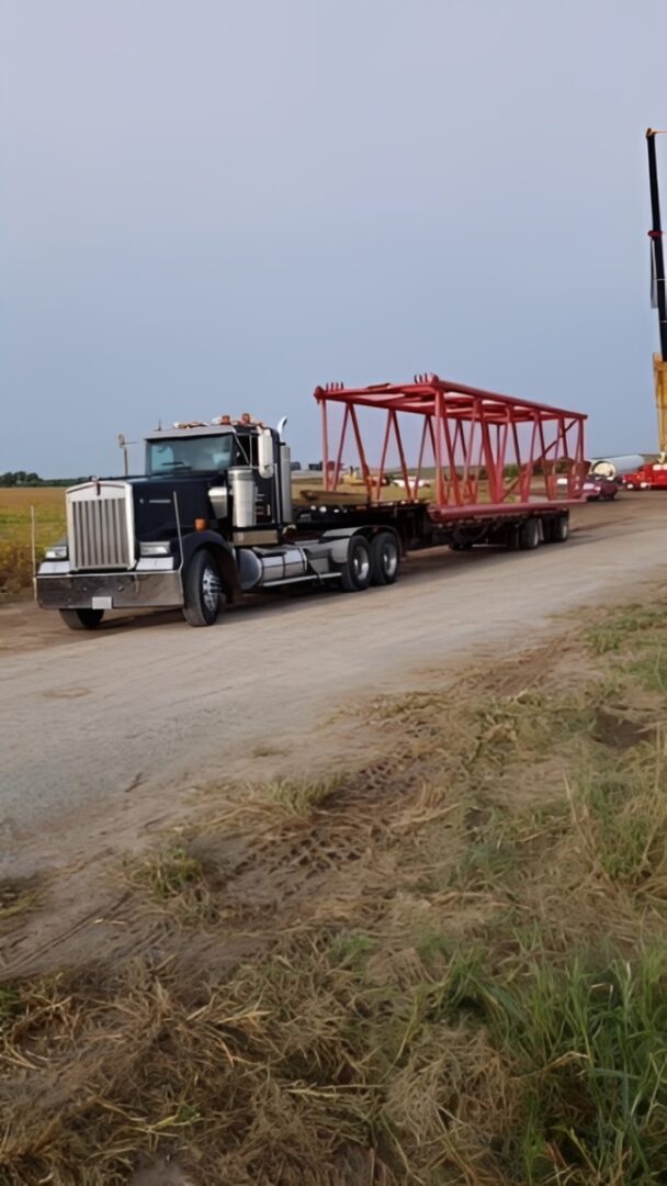 Semi-truck transporting large metal frame
