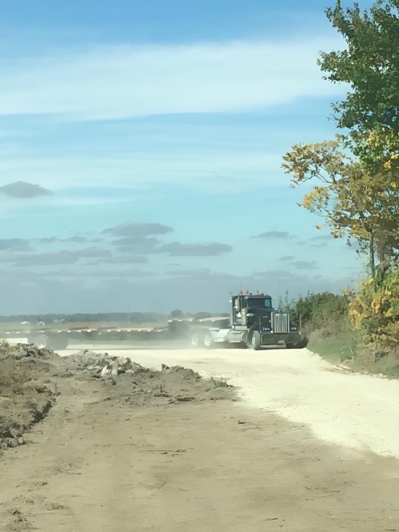 Truck driving on dusty rural road