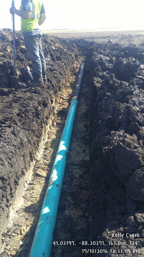 Trench excavation with visible blue pipe