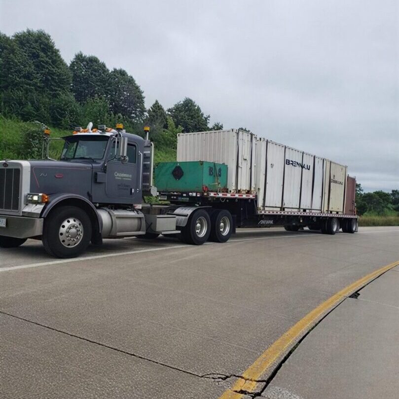Semi truck hauling white shipping containers